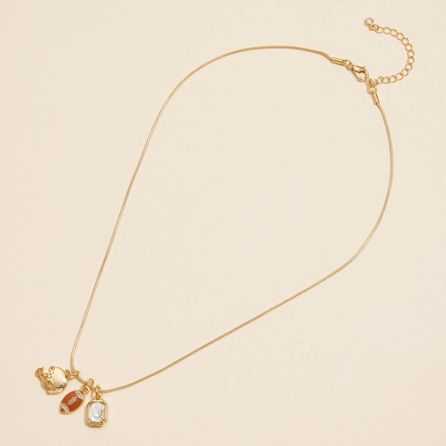 Full view - Gold snake necklace with football, helmet and rectangle clear rhinestone charm