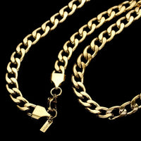 Gold chain necklace with clasp on a black background