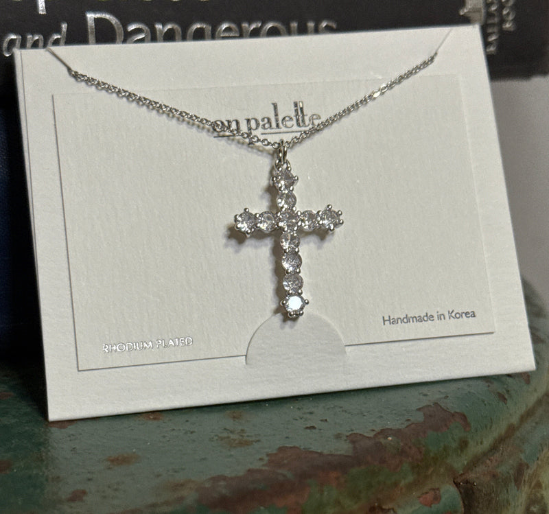 Silver cross necklace on a card 