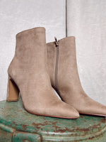 Chinese Laundry Erin Booties in Taupe  Pointed-toe silhouette with zipper closure. Synthetic lining with cushioned footbed. Wrapped heel. Synthetic outsole.Measurements: Heel Height: 3 1⁄2 in Weight: 11 oz Circumference: 10 in Shaft: 7 in